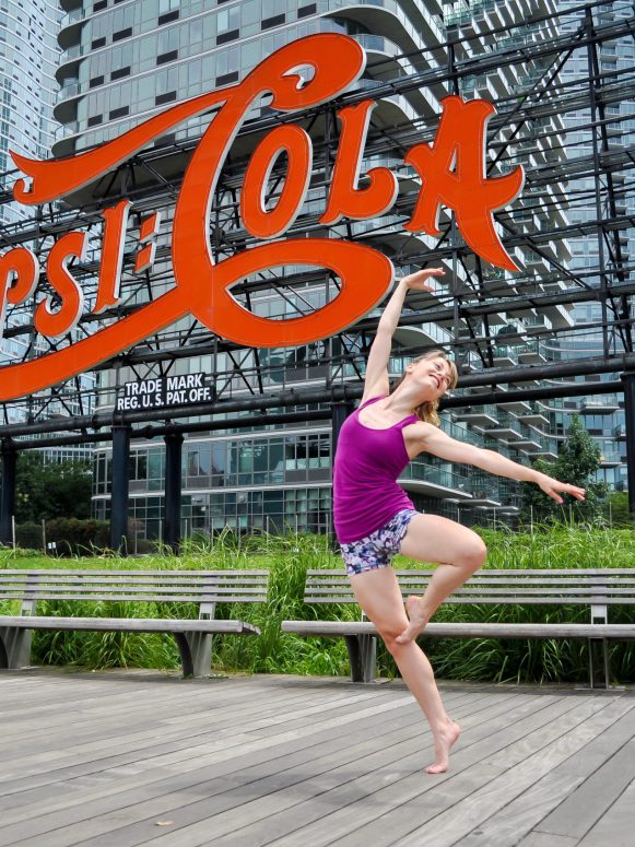 heidi friese of Move With HPA doing a pasé on relevé in front of the pepsi cola sign in long island city, New York